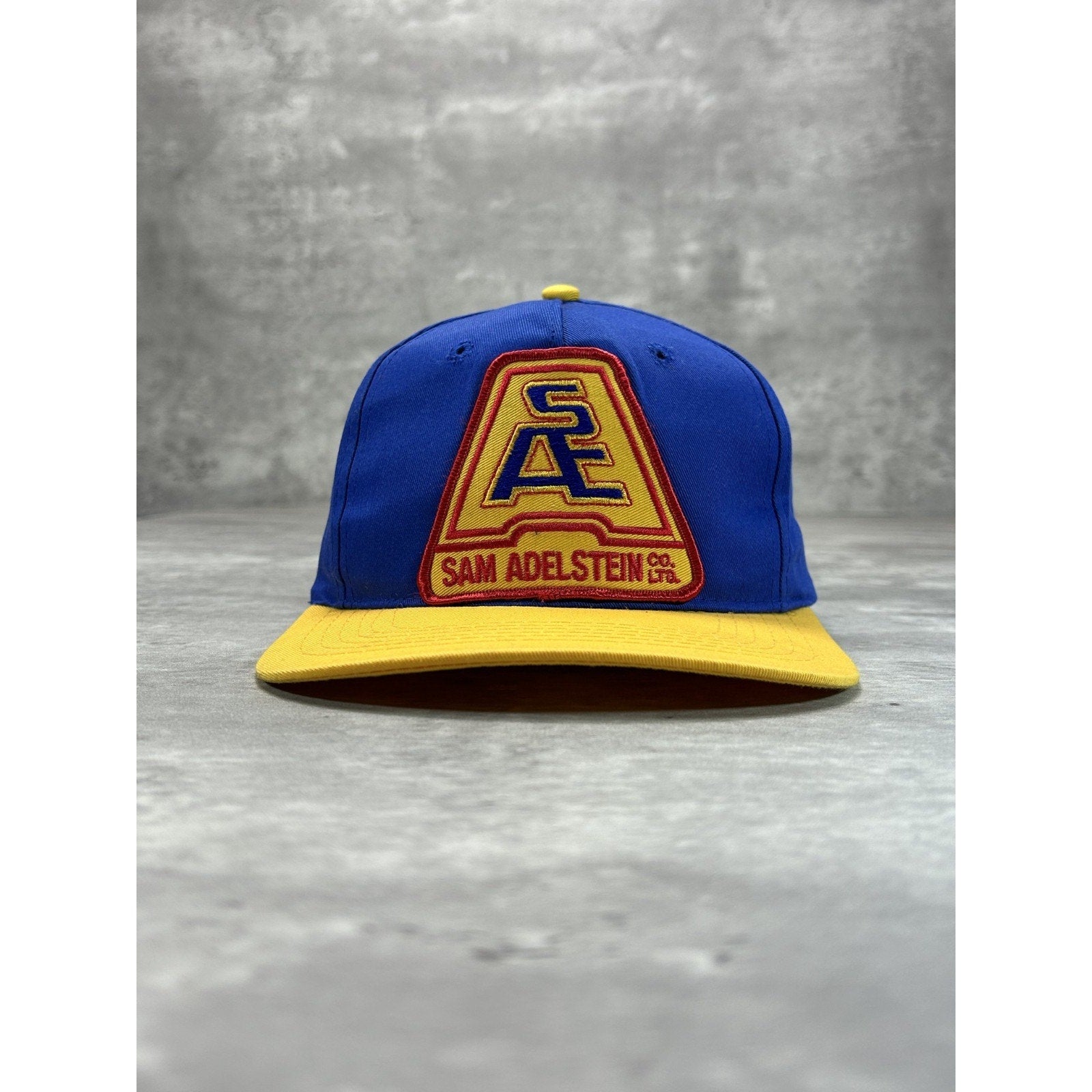 Vintage 90s Sam Adelstein Embroidered Spellout Logo Snapback Hat OSFA